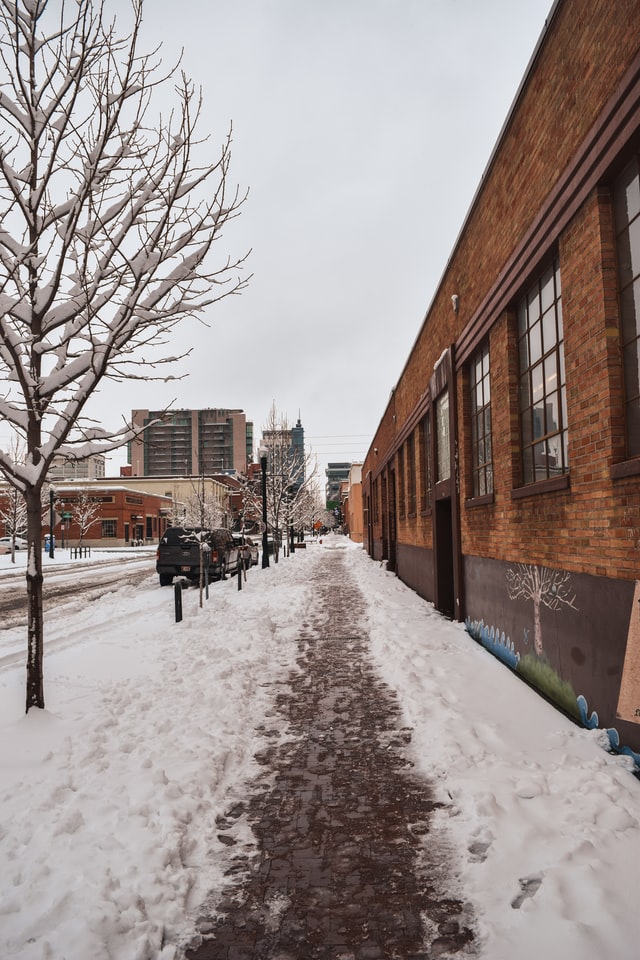 snow on the sidewalk in the city